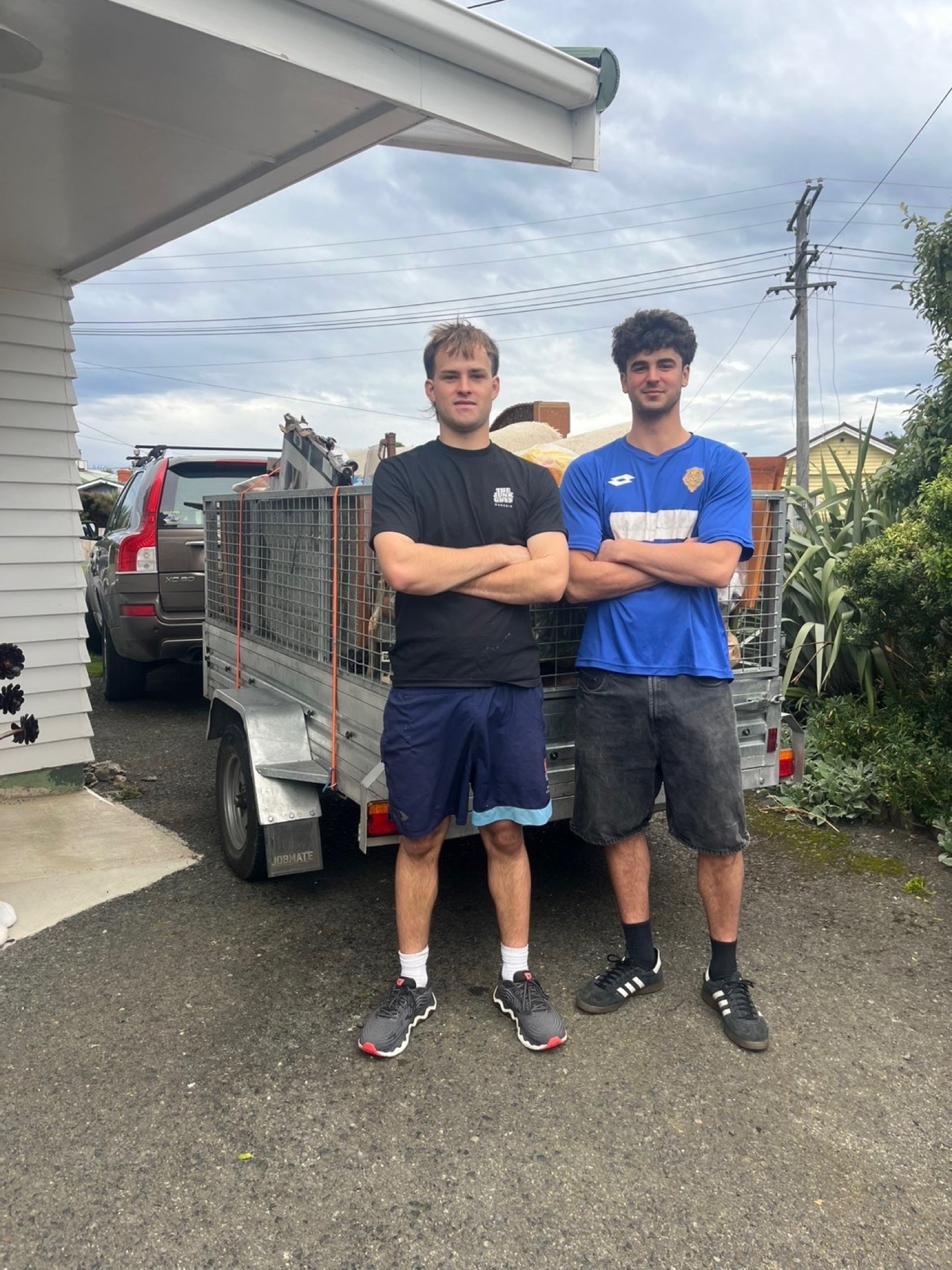 Junk Guys after a job, standing in front of the trailer
