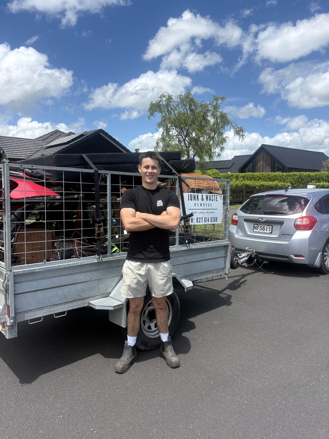 Ryan, founder of The Junk Guys NZ, in front of his trailer